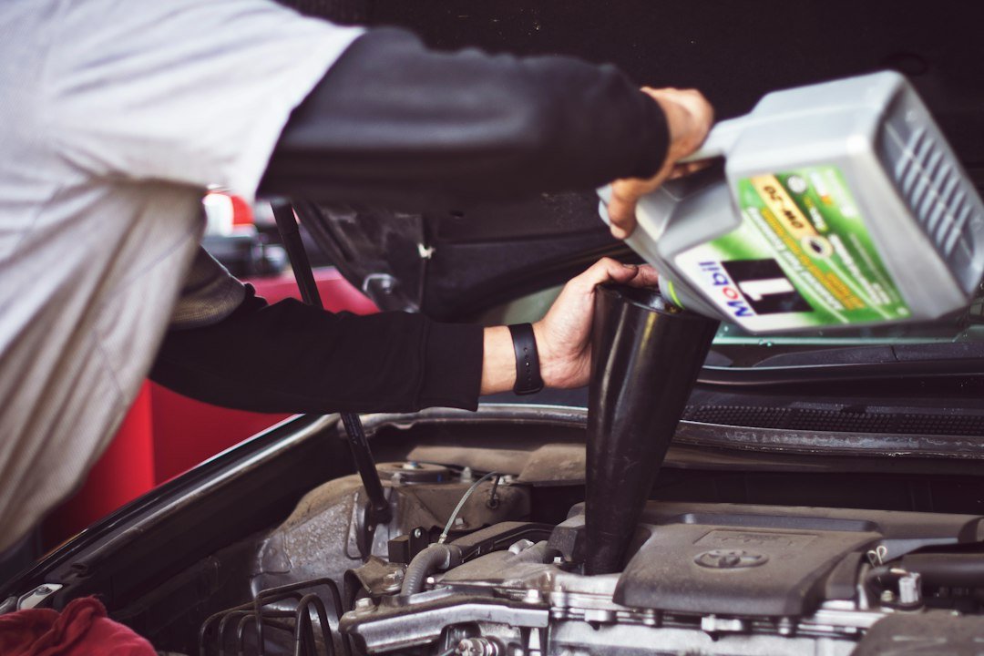 Engine oil being poured into a car engine